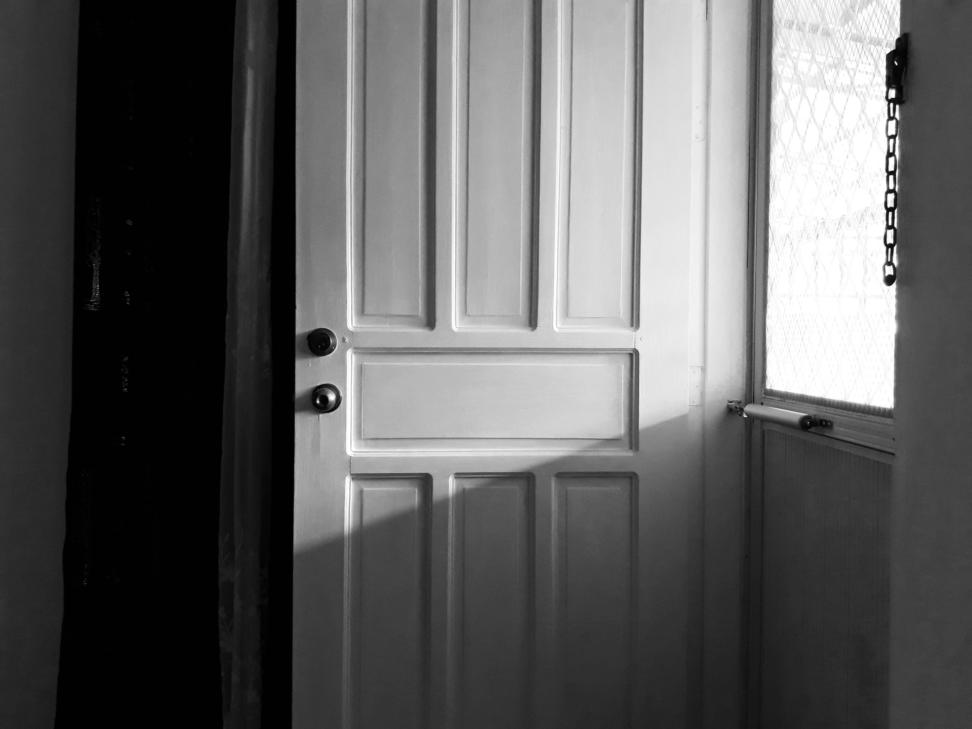white wooden door with black door lever